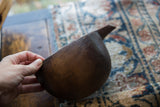 Hand-carved scallop detail on the rim of the vintage African wooden pitcher.