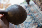 Close-up of the aged wooden pitcher showing historic stitched repairs.