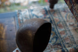 Close-up view of the aged patina and carved details on the vintage wooden pitcher.