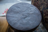 Dark circular top of the African wooden stool, featuring natural wood grain texture.