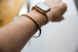 Vintage thin bronze cuff bracelet showing its handmade character on a wrist.