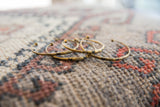 A collection of handmade vintage bronze cuff bracelets with unique patterns.