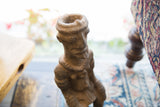 Textured head of the antique African terracotta nkisi fetish figure with vessel opening.