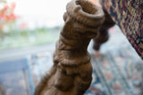 Rough, weathered terracotta texture of the antique African Nkisi fetish figure.
