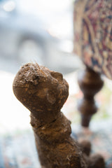 Textured top of antique African terracotta nkisi figure, head broken yet seated.
