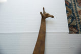 Close-up of the vintage bronze giraffe's head, highlighting its stylized form and etched neck.