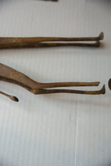 A detailed view of the vintage bronze giraffe's slender, damaged legs.