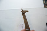 Detailed profile of the vintage bronze giraffe's head with its hand-etched neck patterns.