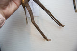 Detail of the vintage bronze giraffe's hand-textured hip and sculpted legs.