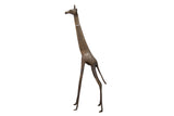 Vintage handmade African bronze giraffe with a stylized, slender body and aged patina.