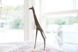 Side view of the vintage African bronze giraffe showing its slender handmade form.