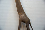 Textured, hand-etched patterns on the neck and body of a vintage bronze giraffe.