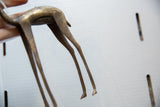 Rear view of the vintage bronze gazelle showing its aged, handmade texture.