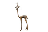 Vintage handmade African bronze alloy gazelle sculpture with an aged patina, facing left.