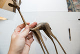 Handmade vintage African bronze gazelle sculpture with textured alloy body.
