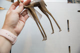 Vintage African bronze gazelle sculpture's slender legs and aged patina.