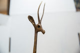 Handmade texture on the vintage bronze gazelle's sculpted head and ridged horns.