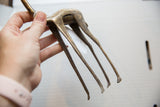The handcrafted body and long, slender legs of the vintage bronze gazelle.