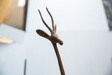 Vintage African bronze alloy gazelle head, featuring textured twisted horns and warm patina.