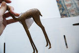 Aged patina detail on the vintage African bronze gazelle's body and slender legs.