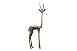 Vintage African bronze gazelle sculpture with an elongated neck and dark, aged patina.