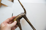 Handmade charm visible in the aged, textured patina of the bronze gazelle body.