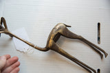 Angled overhead view of the bronze gazelle showing its curved back and aged patina.