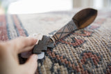 Detailed view of the hand-carved geometric patterns on the vintage spoon's handle.