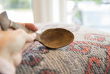 Well-worn, cracked texture and patina inside a vintage African spoon's bowl.