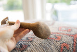Side profile of the vintage African wooden spoon showing its aged texture.