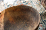 A close view of the rustic, scratched texture inside the vintage wooden bowl.