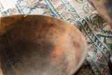 Hand-stitched repair on the weathered rim of a vintage African bowl.