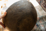 Incised bands of fine lines and triangular motifs on a vintage African wooden bowl.