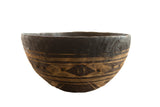 Vintage handmade African wooden bowl, dark brown wood with tan carved geometric patterns.