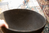 Dark brown interior with prominent wood grain and natural texture of the African bowl.