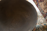 Dark brown textured wood grain on the vintage African bowl's interior.