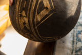 Textured dark wood with light linear etched patterns on the vintage African bowl.