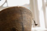 Historic metal stitch repair along a crack on the hand-carved vintage Tuareg bowl.