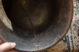 Interior view of the vintage wooden bowl highlighting its aged texture and a crack.