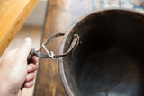Detail of a rustic knotted strap handle on the vintage African wooden bowl.