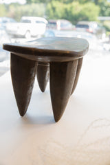 Hand-carved dark wood tapered legs of the vintage Senufo milk stool.