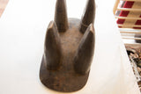 Close-up of the dark wood Senufo stool, highlighting its hand-carved texture.