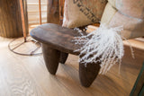 Tapered legs and dark, aged wood texture of the hand-carved Senufo milk stool.