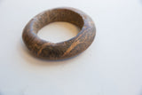 Angled view showing the earthy texture and veining of the antique marble bracelet.