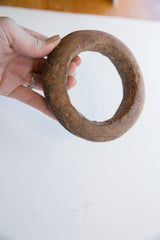 The substantial, hand-carved form of the Neolithic marble bracelet held for scale.