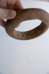 Hand-carved texture and time-worn patina on an antique Neolithic marble bracelet.