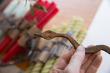 A close view of the hand-forged head and rustic texture of the iron snake.