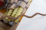 Wavy form and rusted texture of a vintage African iron snake.