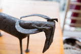 Detailed close-up of the collectible African buffalo's head, showing aged dark metal and etched patterns.
