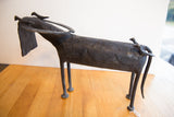 Dark metal legs and feet of the vintage African buffalo figure with a white string.